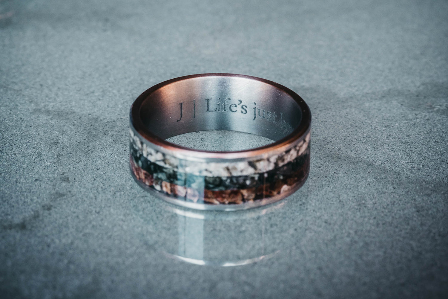 A pair of handcrafted wedding rings made with real mountain stones from Washington, New Zealand, and Germany, custom designed by Honest Hands Ring Co.