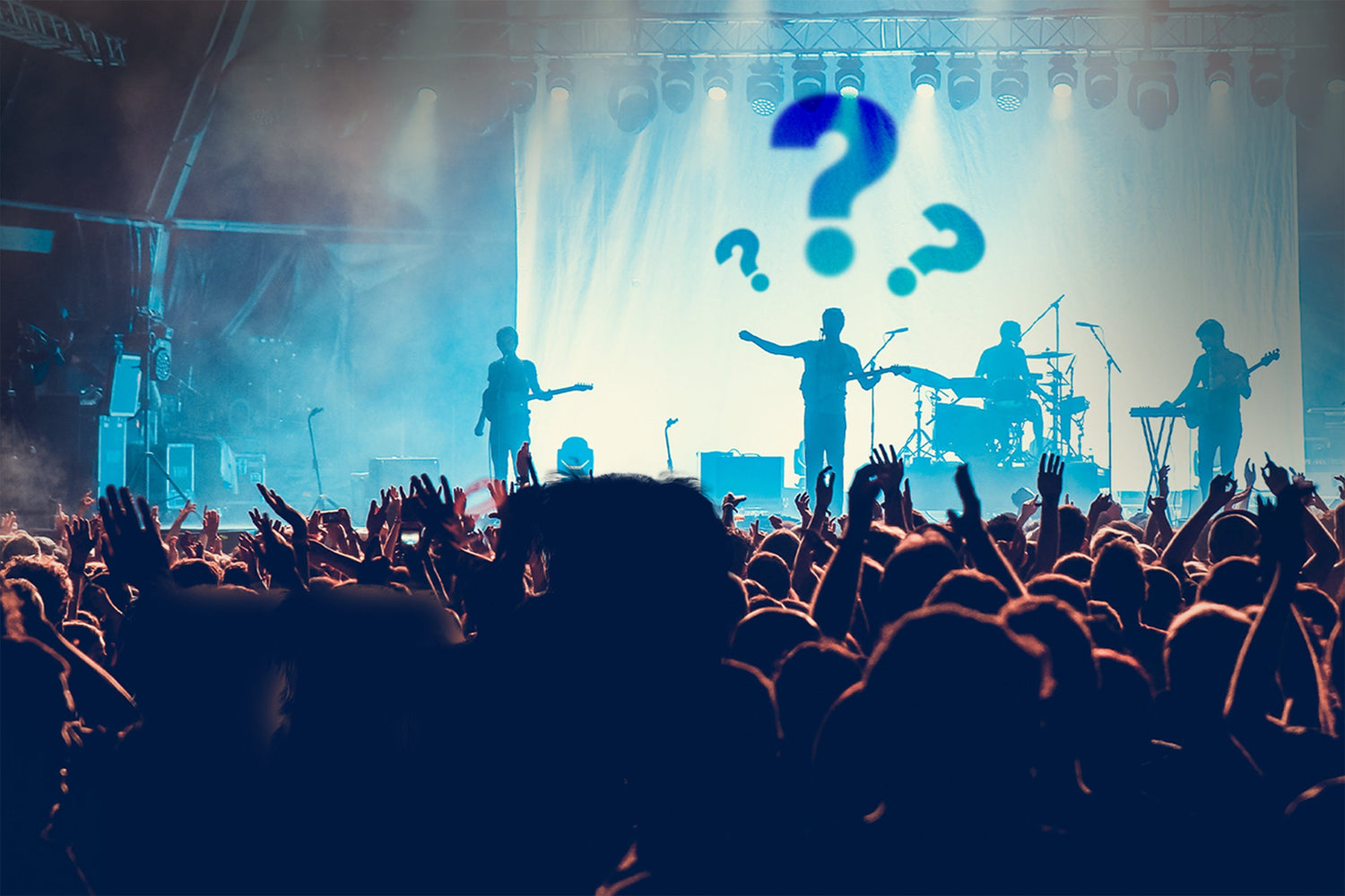 Concert crowd cheering as a band performs on stage, representing the moment Austin secured a guitar string from Ray LaMontagne for a custom wedding ring by Honest Hands Ring Co.