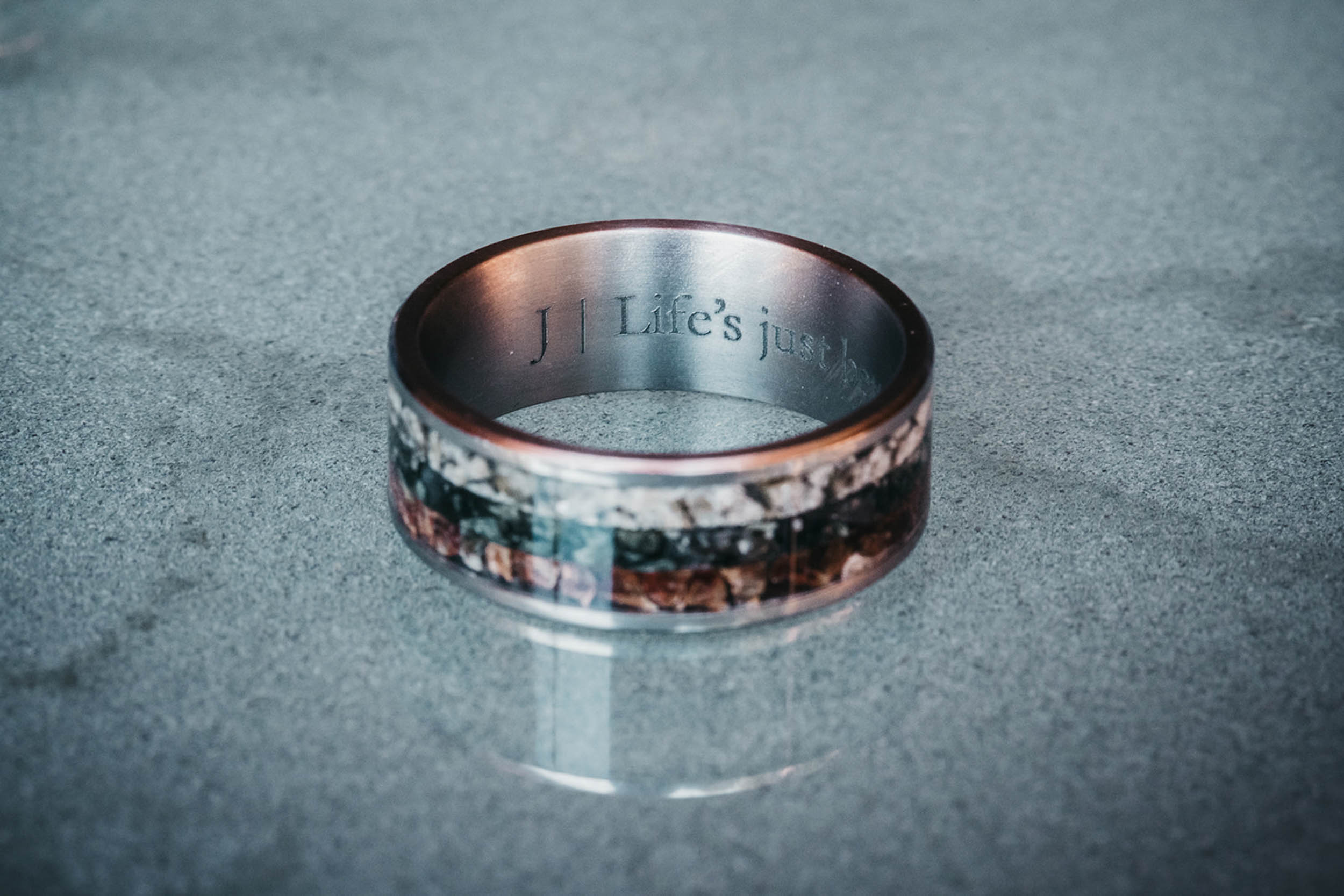A pair of handcrafted wedding rings made with real mountain stones from Washington, New Zealand, and Germany, custom designed by Honest Hands Ring Co.