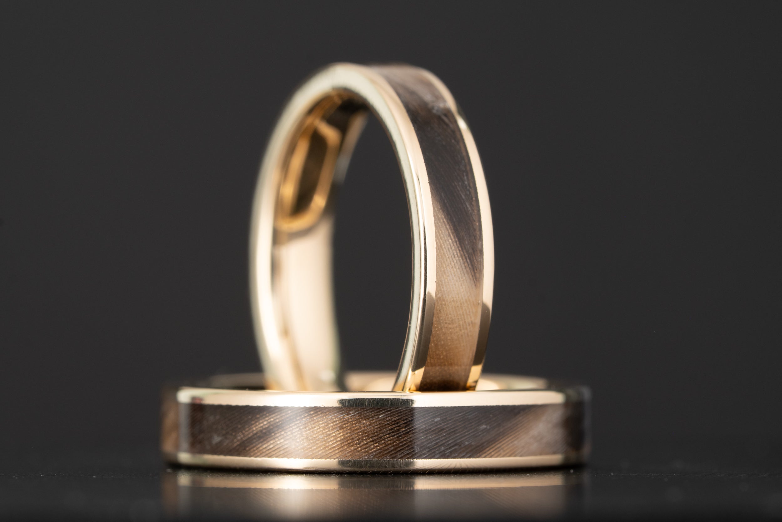 Tellurium copper wedding band with a crushed Keweenaw copper and Isle Royale greenstone inlay, showing bare copper flecks through the dark green stone, handcrafted by Honest Hands in Morrison, Colorado.
