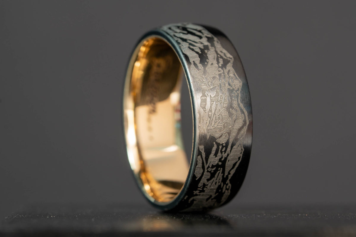 Honest Hands black titanium ring engraved with the Colorado 14ers as seen from Golden, with a hidden 14k yellow gold inlay made from two melted wedding bands.